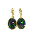 Ethiopian Welo black opal earrings with bluish green and fire red orange, set in 14K yellow gold.