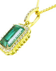 The left side profile of a natural colombian emerald pendant in yellow gold,
