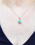 Halo pear shape emerald pendant