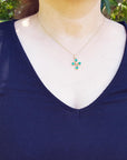 Yellow gold emerald cross necklace