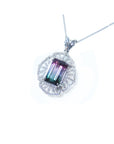 A tourmaline and diamond necklace in white gold with on a white background.