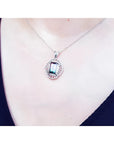 Watermelon tourmaline pendant necklace with emerald cut, bluish-green and pink stone, diamond accents, 14K white gold.