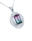A watermelon tourmaline pendant necklace with a rectangular emerald cut and accenting natural diamonds set in 14k white gold.