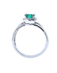 14K white gold engagement ring with a natural emerald centerpiece and three rows of halo diamonds.