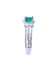 14K white gold engagement ring with a natural emerald centerpiece and three rows of prong-set diamonds.