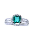 An affordable emerald engagement ring and diamond-studded band crafted in 14k white gold.