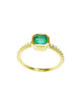 14K yellow gold ring with a medium green emerald in a tapered bezel, flanked by natural diamonds.