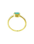 14K yellow gold ring with a medium green emerald in a tapered bezel, flanked by natural diamonds.