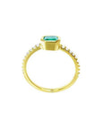 14K yellow gold ring with a medium green emerald in a tapered bezel, flanked by natural diamonds.