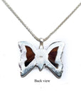 Back view of a sterling silver butterfly pendant necklace with orange, brown, and black agate.