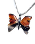 Sterling silver necklace with an orange, brown, and black agate butterfly pendant.