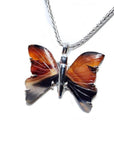 Sterling silver necklace with an orange, brown, and black agate butterfly pendant.
