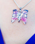 Handcrafted sterling silver butterfly agate pendant necklace with pink and colorful wings.