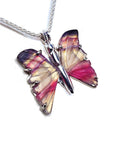 Agate butterfly-shaped silver pendant with pink and purple wings on a white background