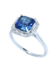 Asscher cut blue sapphire ring with halo diamonds in 18k white gold.