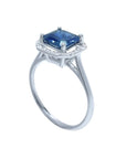 Asscher cut blue sapphire ring with halo diamonds in 18k white gold.
