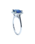 Asscher cut blue sapphire ring with halo diamonds in 18k white gold.