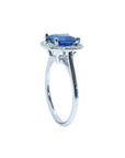 Asscher cut blue sapphire ring with halo diamonds in 18k white gold.