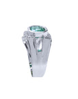 An emerald ring for men displaying the top and side band design in white gold.