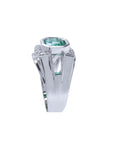 An emerald ring for men displaying the top and side band design in white gold.