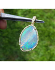 12.16 ct. Australian opal pendant with bluish-green play-of-color, handcrafted in 18K yellow gold.