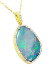 12.16 ct. Australian opal pendant with bluish-green play-of-color, set in 18K yellow gold with diamonds.