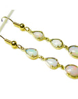 Handcrafted 14k yellow gold dangle earrings with three pear and oval-shaped natural Australian opals.