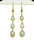 Pear and oval Australian opal dangle earrings in 14k yellow gold.