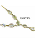 Gold necklace with opal stones on a upside down position to display its back side view.