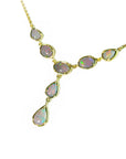 A solid Australian opal necklace with gold chain on a left-side profile view position.