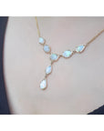 Handcrafted 14K yellow gold necklace with seven solid Australian opals, worn on a person.