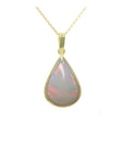 A solid Australian opal pear shaped pendant necklace on a gold chain showing the topside profile view.