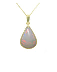 A solid Australian opal pear shaped pendant necklace on a gold chain showing the topside profile view.