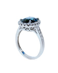 18K white gold ring with a large oval bluish-green Australian sapphire surrounded by a diamond halo.