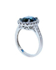 18K white gold ring with a large oval bluish-green Australian sapphire surrounded by a diamond halo.