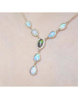Necklace with opal stones on a light pink background