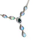 14k yellow gold necklace with a black Australian opal center, diamond halo, and pear-shaped opals.