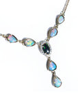 14k yellow gold necklace with a black Australian opal center, diamond halo, and pear-shaped opals.