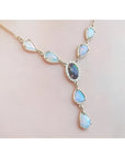 14k yellow gold Australian black opal and diamond halo necklace with teardrop opals.