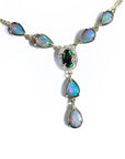 14k yellow gold necklace with a black Australian opal haloed by diamonds, and seven pear-shaped opals.