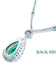Back view of 18K white gold necklace with pear-cut emerald pendant and diamond halo.