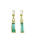 14K gold stud earrings with baguette emeralds, pear-shaped diamonds, and tapered baguette diamonds.