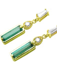 Left side profile of a pair of emerald and diamond baguette earrings, top and underside view