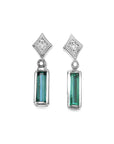 Pair of earrings with baguette natural emeralds and diamond tops on a front side top view position