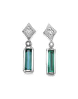 14K white gold emerald baguette and diamond stud earrings.