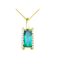 Baguette cut Colombian emerald pendant in 18K yellow gold with diamond accents.