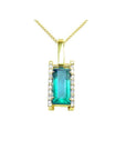 Baguette cut Colombian emerald pendant in 18K yellow gold with diamond accents.