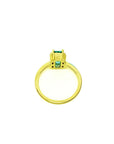 18K yellow gold ring with a baguette-cut emerald and side diamonds.