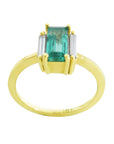 Emerald baguette cut ring 18k yellow gold band on a white background.