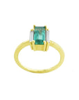 Emerald baguette cut ring 18k yellow gold band on a white background.